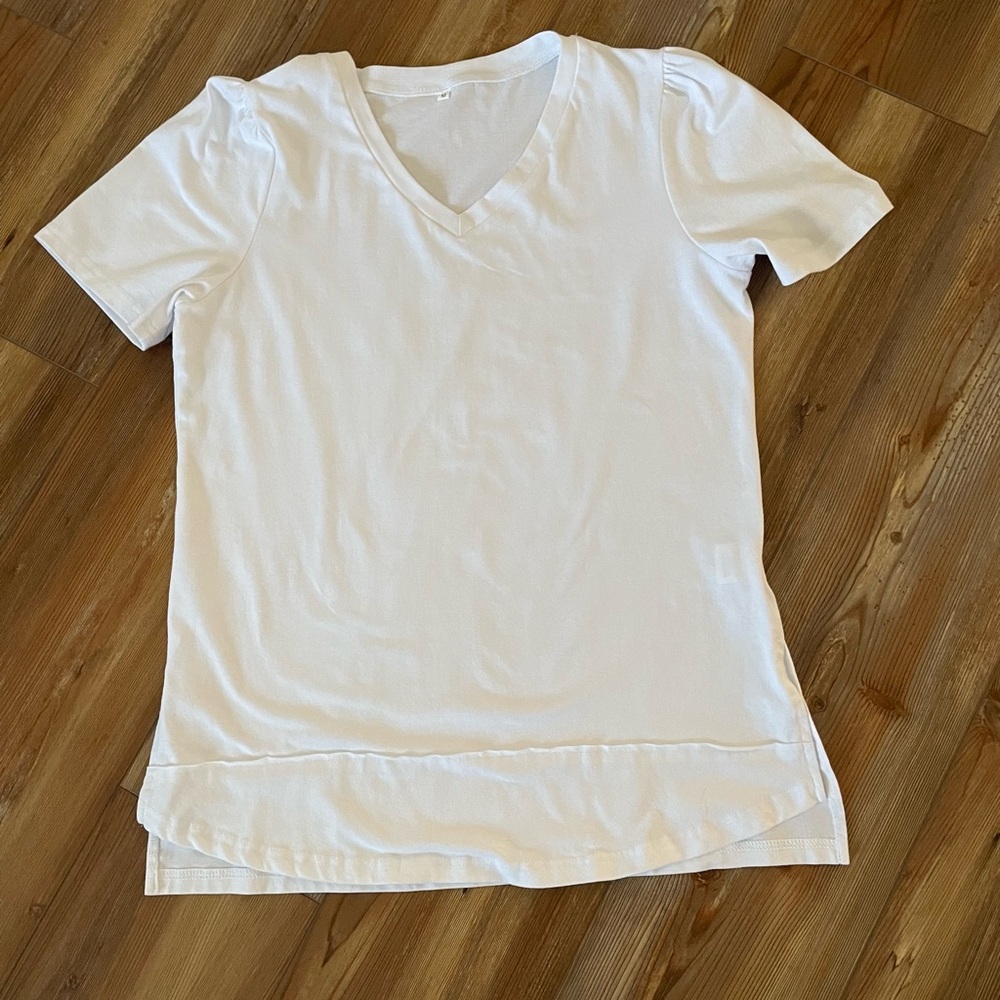 Medium white tshirt. Brand new. Never worn. From Amazon.